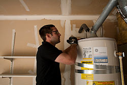 Jack repairing a broken water heater